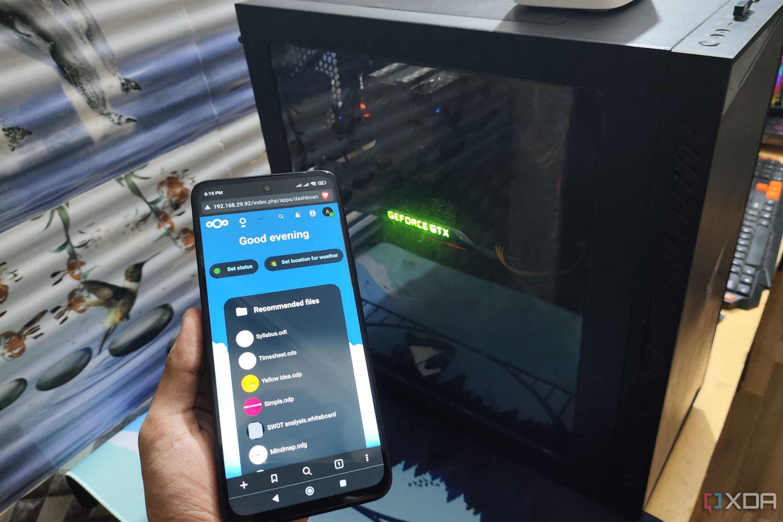 The Nextcloud UI displayed on a Poco M6 Pro, with a PC in the background